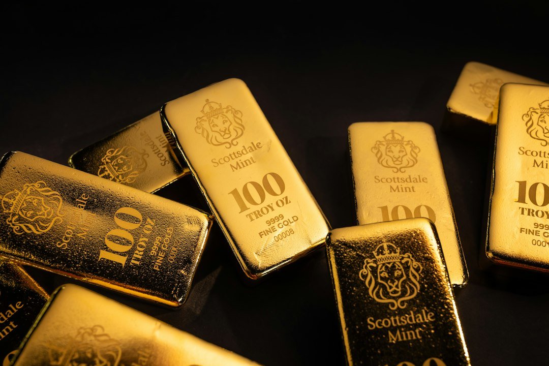Gold bullion bar on a dark background, illustrating gold investment education