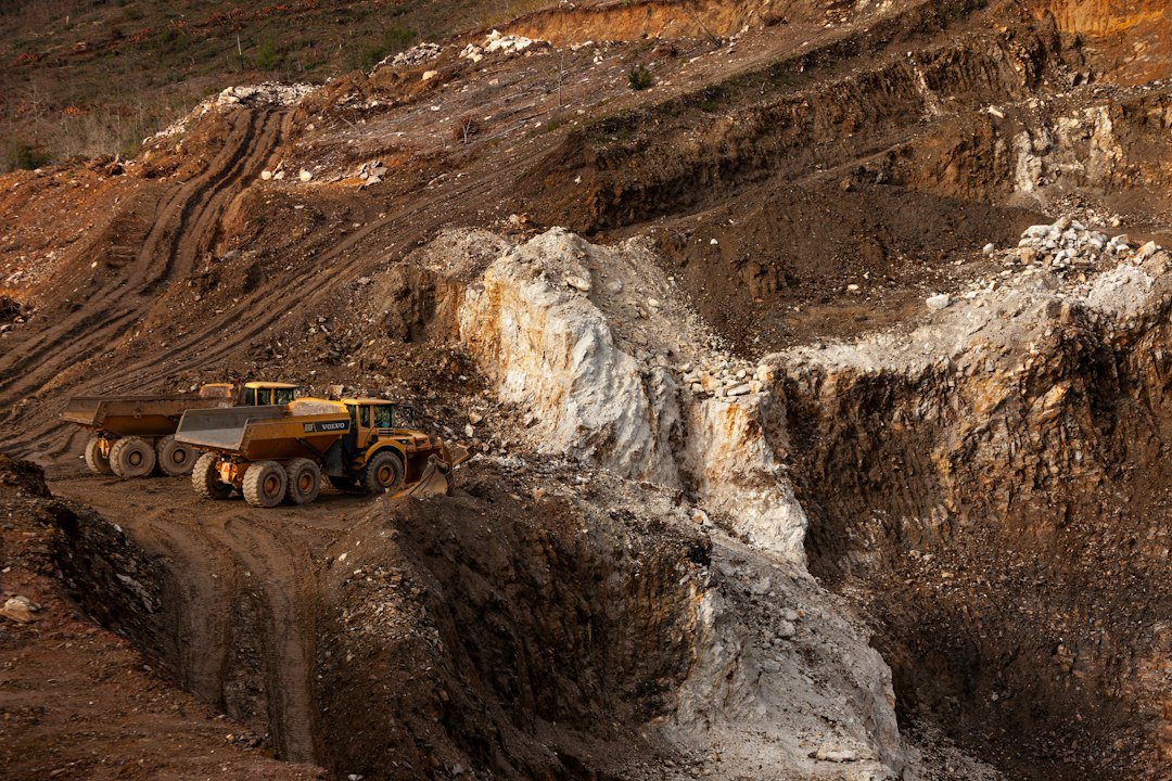 Exposed rock benches in an open-pit quarry illustrating ore and waste classification