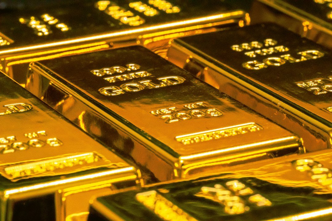 Gold bars and coins illustrating producer hedging and gold price risk management