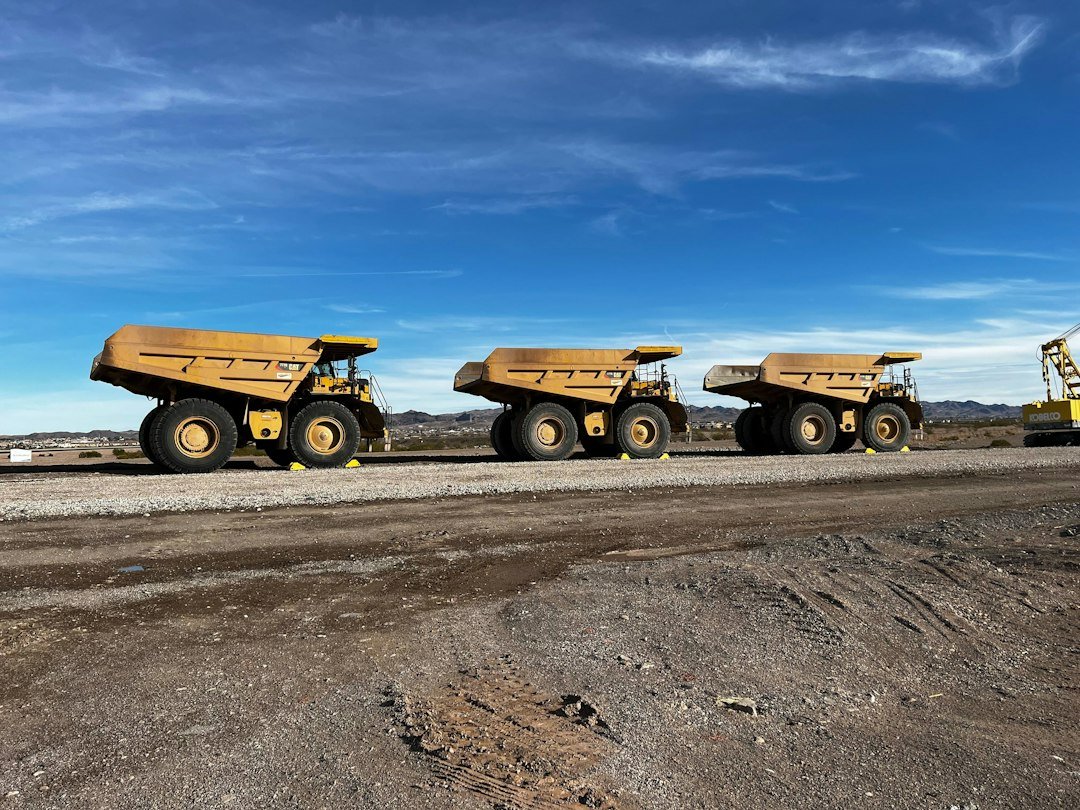Large haul trucks moving rock at an open-pit mine in Nevada