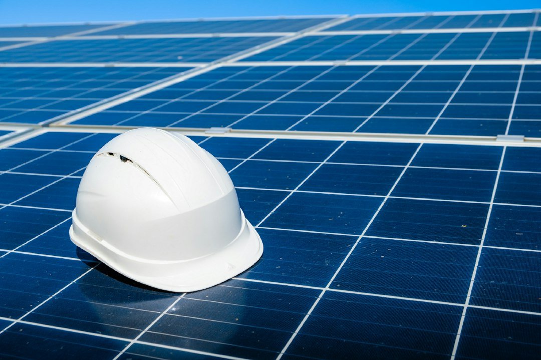 Engineering plans and safety helmet resting on solar panels